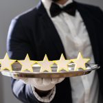 A butler holding a 5 stars on a plate