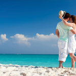 A couple hugging on the beach in Bali on their honeymoon