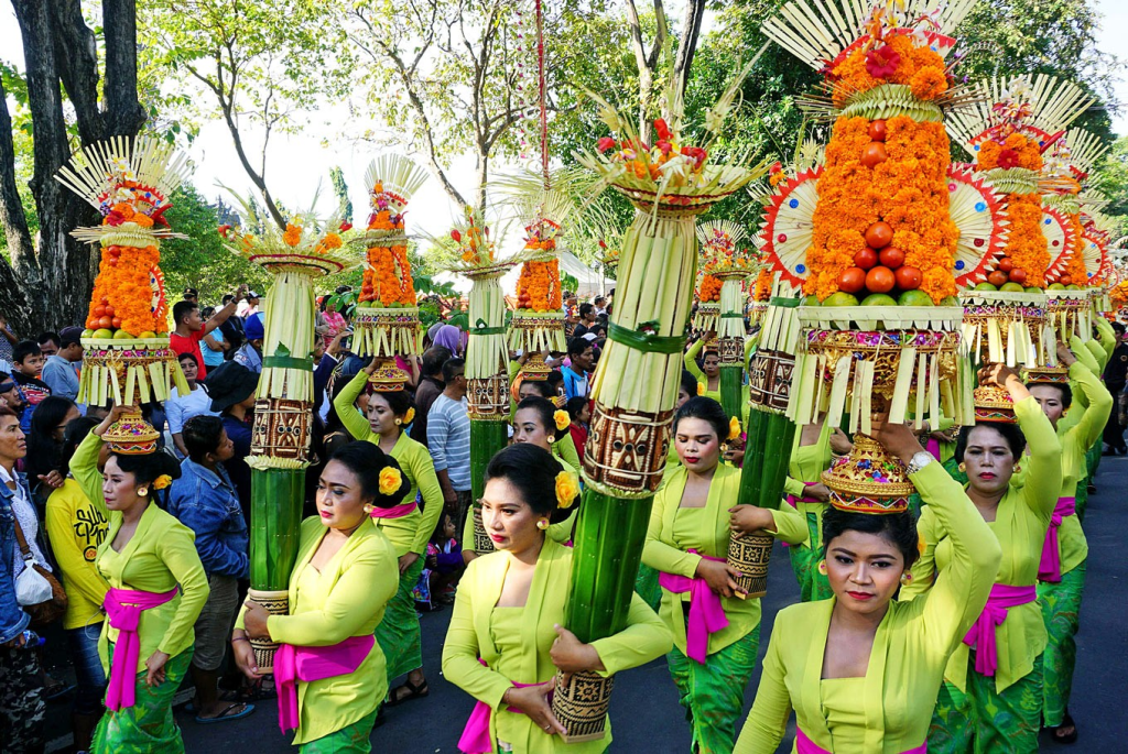 Balinese women holding eleborate offerings for traditional Bali holiday ceremony