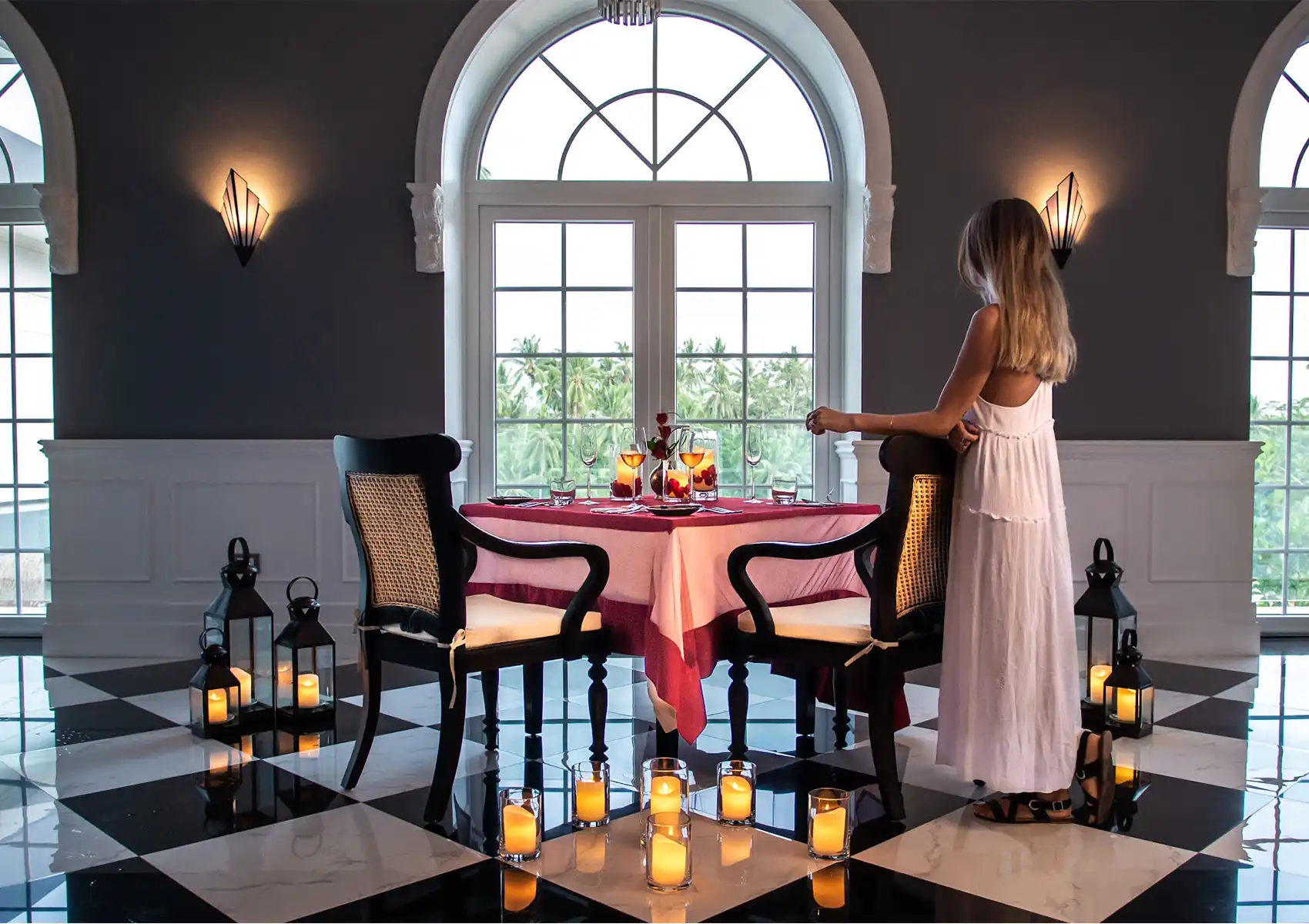 Romantic Bali honeymoon package dinner setup with candles, flowers, and elegant table for two.