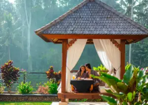 Couple enjoying a romantic breakfast in a private balé surrounded by tropical jungle views at Viceroy Bali in Ubud.