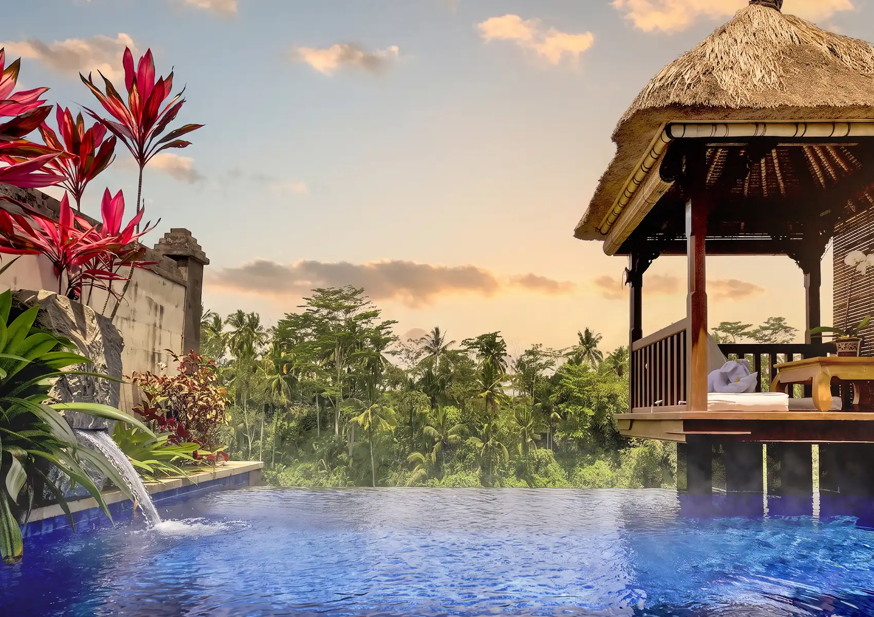 A steaming heated private infinity pool and traditional bale overlooking a dense, tropical jungle at a boutique retreat Ubud.