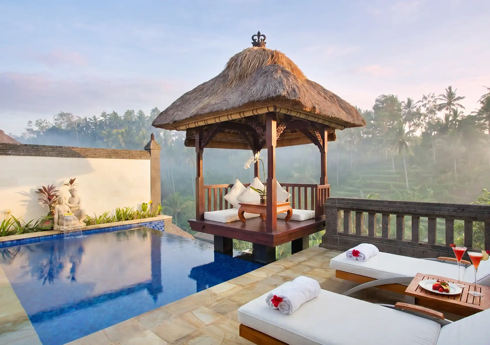 A traditional Balinese feast featuring yellow rice and flavorful side dishes served in ornate red and gold bowls for a holiday dinner at a boutique hotel in Ubud.